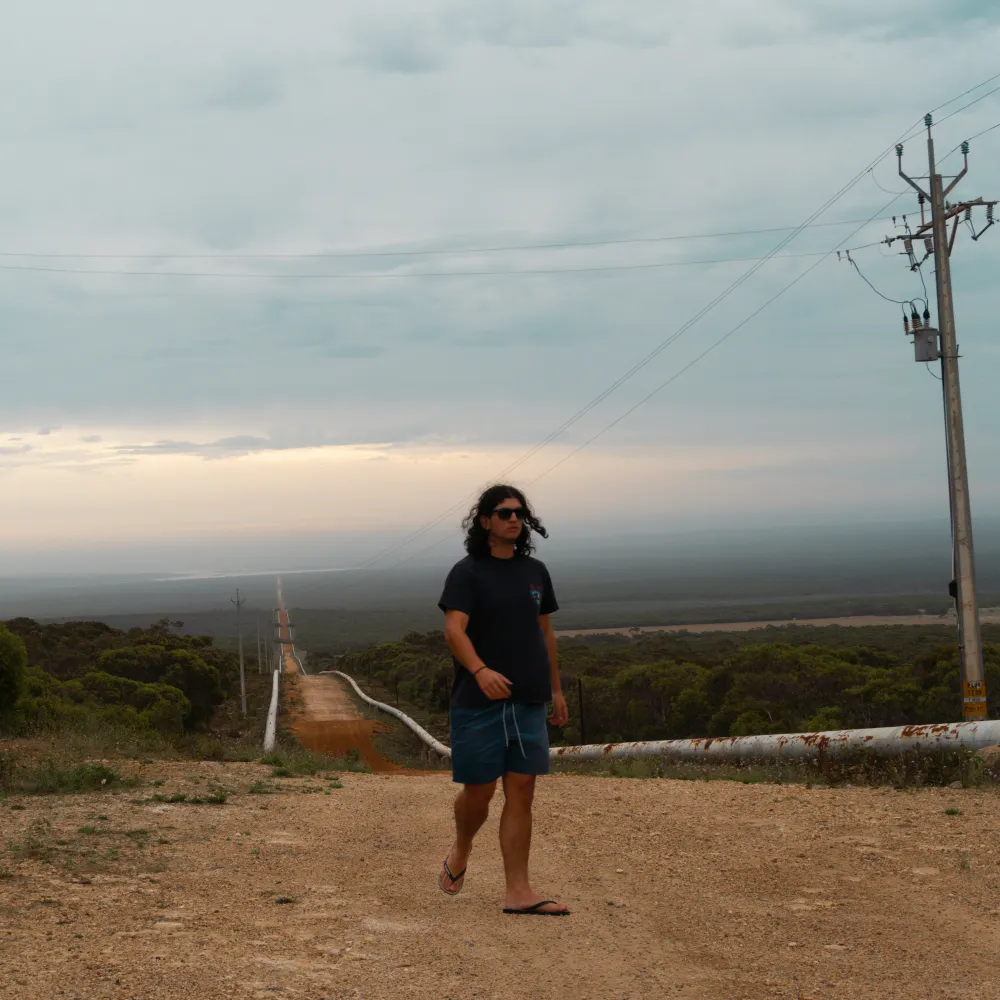 Kaya walking a dirt road through the Australian bush